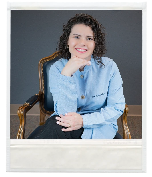 A woman in a blue shirt sitting in a chair at the dentist in New Braunfels.